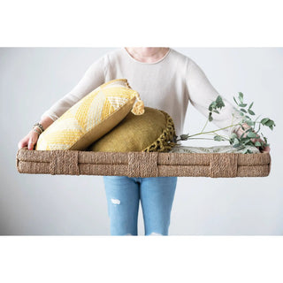 Hand-woven Bankuan tray with handles in natural brown, holding yellow patterned cushions.