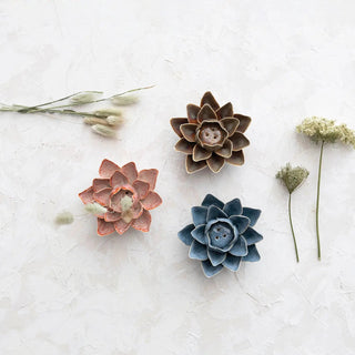 Handmade stoneware flower incense holders trio in red-orange, brown, and blue with reactive glaze.