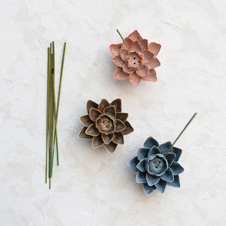 Handmade stoneware flower incense holder set of three in pink, brown, and blue reactive glaze.