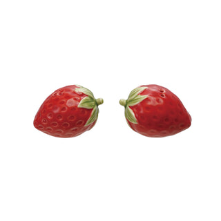 Two strawberry-shaped salt and pepper shakers, hand-painted red with green leaves, ceramic serveware