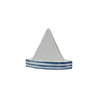 Sailboat-shaped stoneware napkin holder with white sail and blue striped base.
