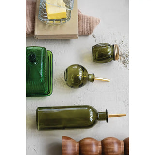 Olive-green glass oil cruet with a gold-tone metal stopper
