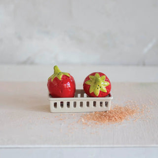 Stoneware strawberry salt and pepper shakers, two red with green tops in a white berry-basket holder
