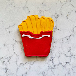 Lunch Menu cookie shaped like french fries in a red carton with yellow icing