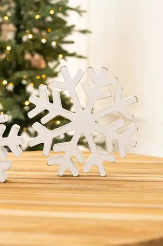 Two white chunky wood snowflake cutouts, 8x8 inches, for Christmas decor.