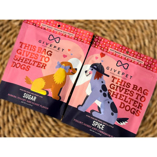 Sugar and Spice Soft-Baked Dog Treats in two pink bags with illustrated dogs; banana yogurt and honey flavor, cinnamon flavor.