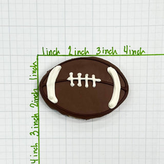 Football-shaped chocolate cookie with white icing laces