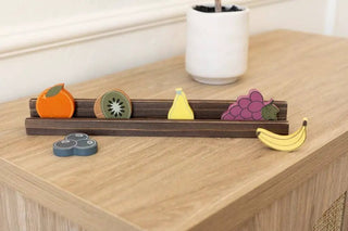 Wood fruit shapes set (6) for letterboard, colorful assorted fruit pieces on a dark wooden rack