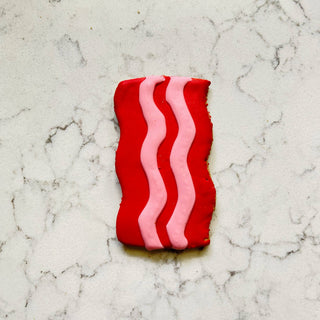 Dapper breakfast cookie with red base and pink wavy icing