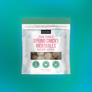 The Only Spring Chicky Meatballs dog treats bag with green top; pastel Easter eggs design and window showing meatballs.