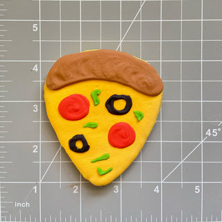 Dapper lunch menu pizza-shaped dog treat with yellow base, brown crust, red pepperoni, black olives, green herbs