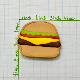 Lunch Menu Dapper dog treat hamburger cookie with brown bun and bright green, red, and yellow icing.