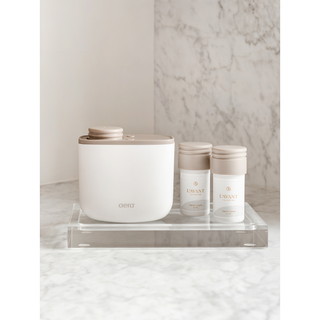 Lucite Tray - Medium with two small bottles displaying brand logos on a clear acrylic tray