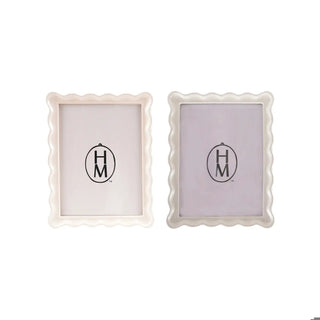 Two resin scalloped photo frames in cream and white, 7-1/4W x 9-1/4H.