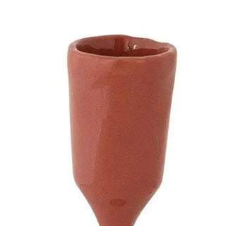 Enameled cast iron taper holder in terracotta red for home decor.