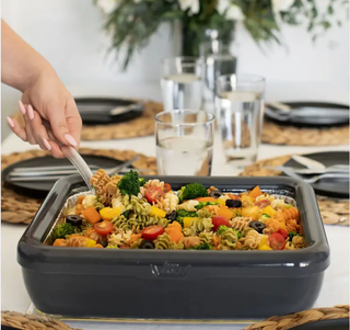 Premium serving tray in dark gray holding a colorful pasta dish