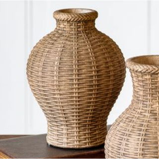 Pair of natural-woven vases on a wooden surface with brown wicker texture.