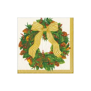 Cocktail napkin featuring Magnolia wreath, green foliage, red berries, and a gold bow with a gold border.