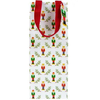 Little Nutcracker bottle gift bag with red handles and a repeating nutcracker pattern on white background.