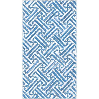 Guest towel napkin in blue fretwork pattern for an elegant tabletop setting
