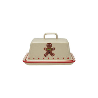 Stoneware butter dish with lid, featuring a gingerbread man and red dotted trim.