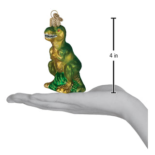 T-rex ornament perched on a hand; glittery green and gold dinosaur decor, 4 in tall
