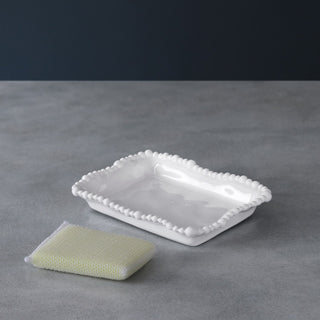 Kitchen sponge holder in white melamine with a beaded edge, paired with a yellow sponge