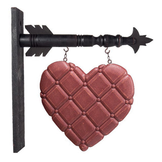 Arrow ornament with a red wood heart featuring a criss-cross quilted pattern